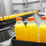Orange Juice Bottles On Factory Assembly Line